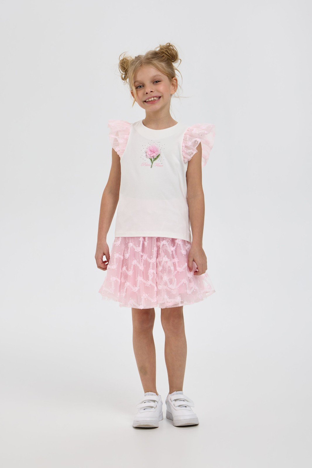 Girl modelling white and pink ruffle top with matching tulle skirt