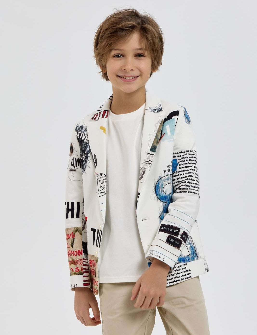 Boy modelling a white graphic-print blazer over a plain T-shirt