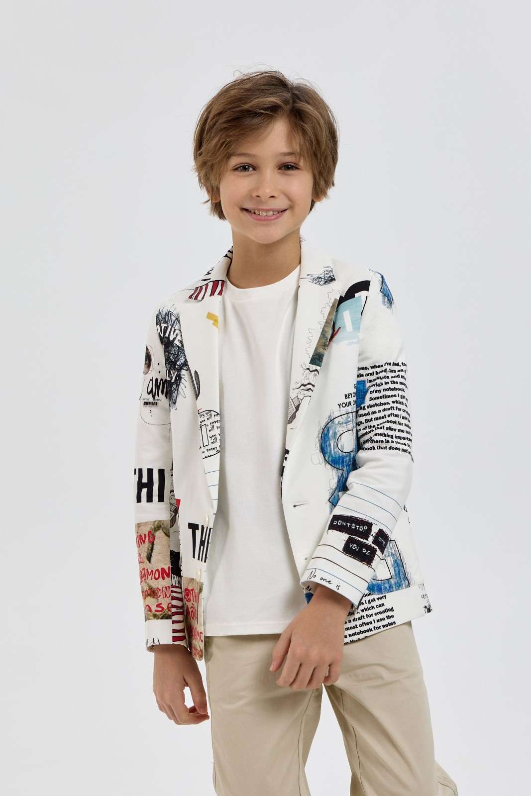 Boy modelling a white graphic-print blazer over a plain T-shirt