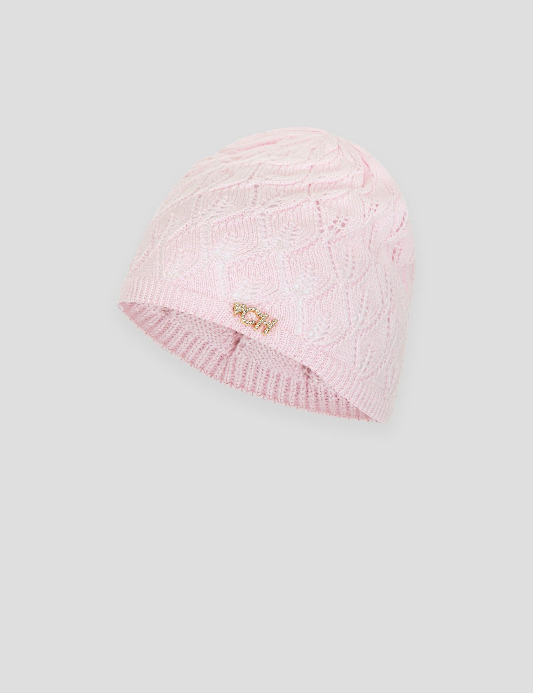 Pink knitted children's beanie with cable pattern and small charm