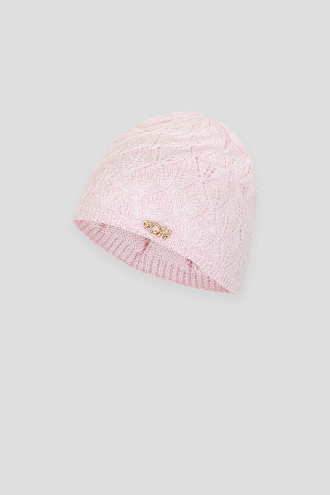 Pink knitted children's beanie with cable pattern and small charm